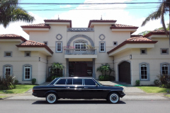 LIMOUSINE IN FRONT OF LARGE MANSION COSTA RICA
